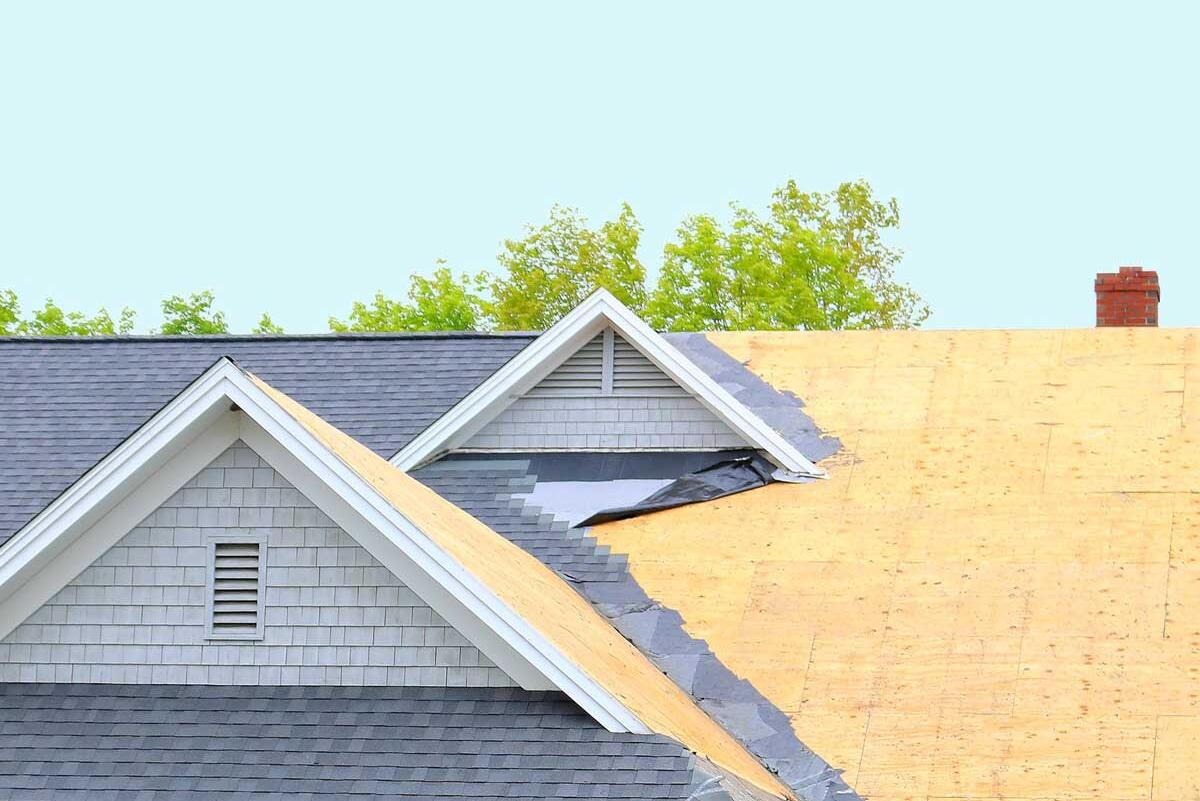 a half finished roof with shingles and plywood